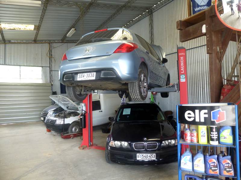 car on a lift above another car