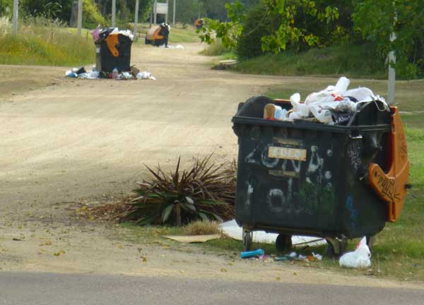 Overflowing trash containers, days before tourist season starts, Atlántida, Uruguay